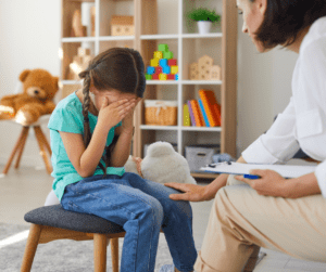 A therapist comforts a crying child
