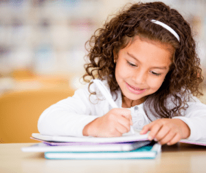A child writes in a workbook