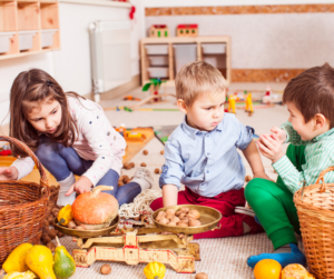 Three children play with basket of toys